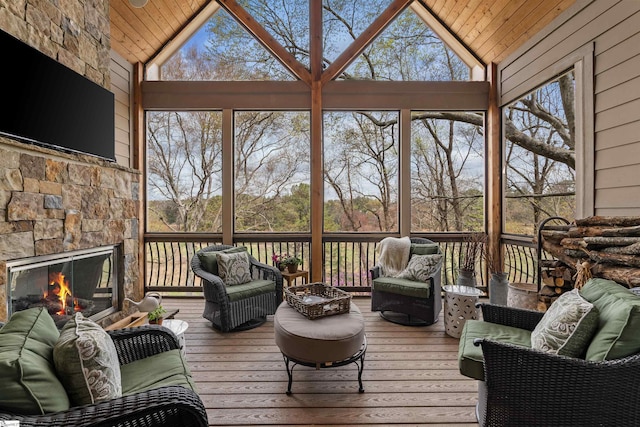 sunroom with an outdoor living space with a fireplace