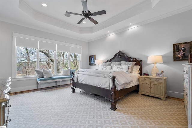bedroom featuring a tray ceiling, crown molding, recessed lighting, baseboards, and visible vents