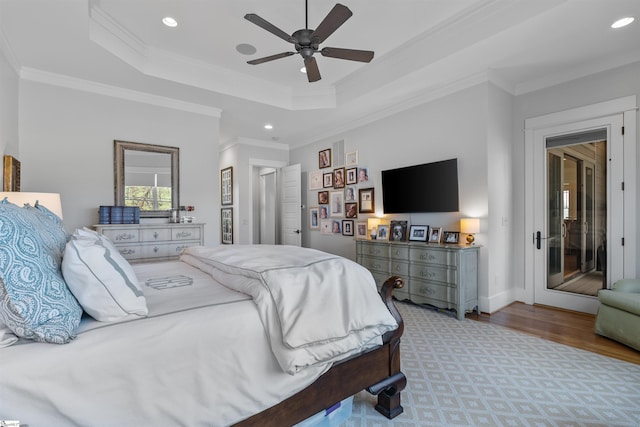 bedroom with crown molding, recessed lighting, and a raised ceiling