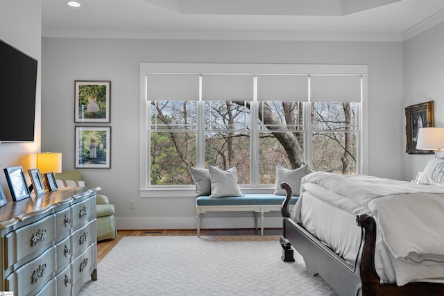 bedroom with baseboards, crown molding, wood finished floors, and recessed lighting
