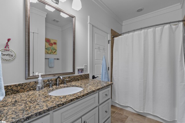 full bathroom featuring a shower with curtain, vanity, ornamental molding, and visible vents