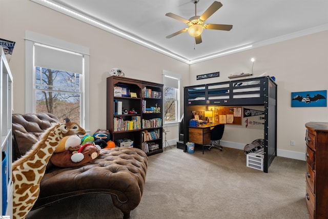 carpeted bedroom featuring crown molding, baseboards, and ceiling fan