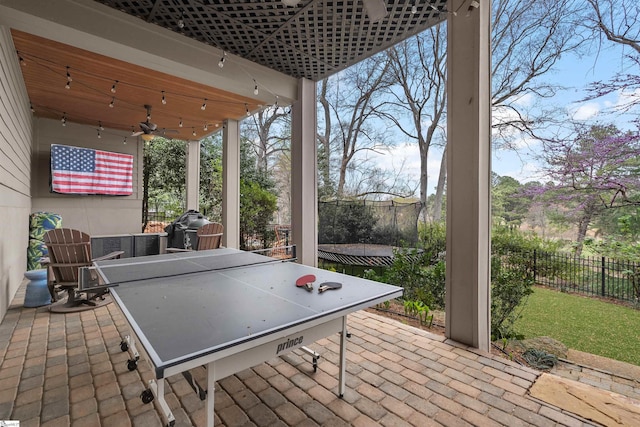 view of patio featuring fence and a ceiling fan