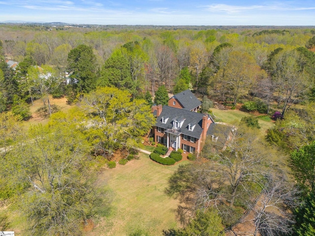 birds eye view of property featuring a view of trees