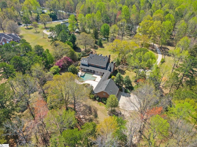 birds eye view of property with a wooded view