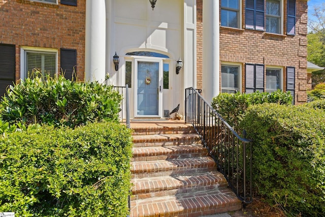 doorway to property with brick siding