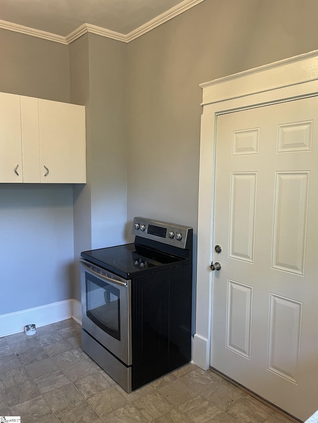 kitchen with white cabinets, stone finish flooring, baseboards, ornamental molding, and stainless steel electric range
