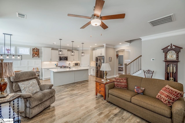 7 Ridgebury Pl, Greenville, SC 29607 - living area with arched walkways, light wood-style flooring, visible vents, and a ceiling fan