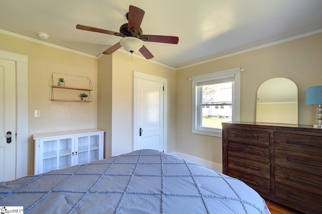 bedroom featuring crown molding, baseboards, and ceiling fan