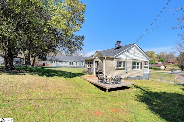 rear view of house featuring crawl space, a wooden deck, fence, and a yard