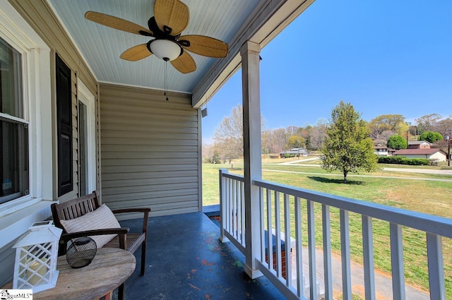 balcony with a porch and a ceiling fan