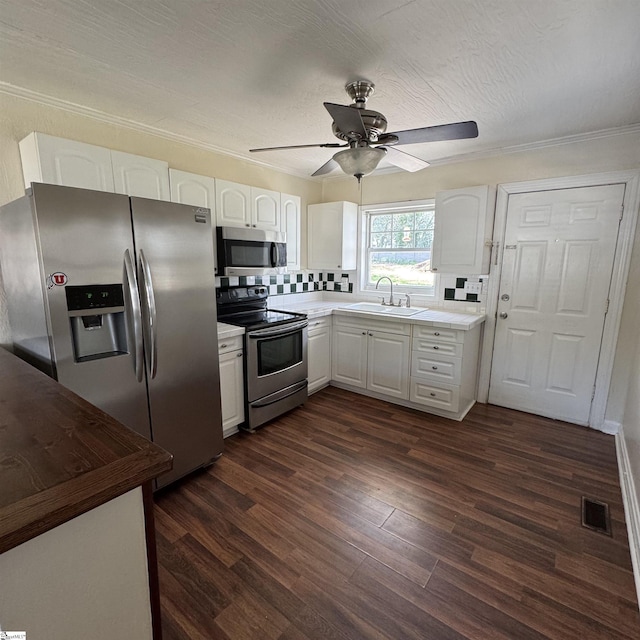 kitchen with a sink, stainless steel appliances, visible vents, white cabinets, and ceiling fan