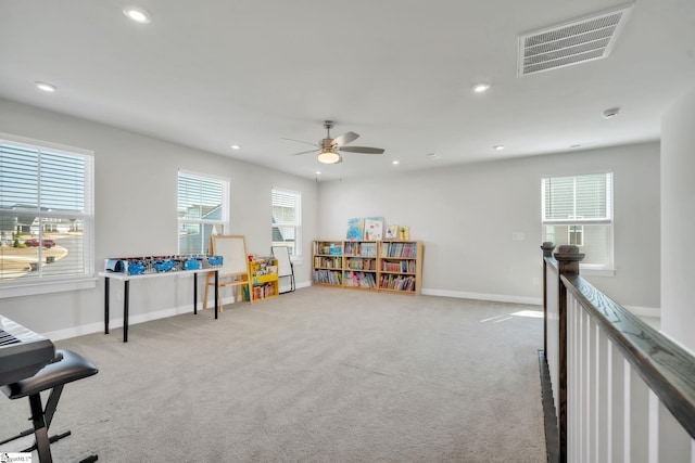 playroom with carpet floors, baseboards, and visible vents