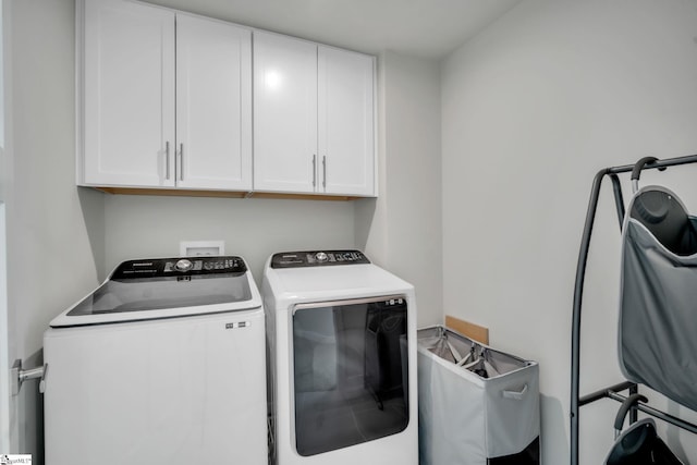 laundry area featuring cabinet space and washing machine and clothes dryer