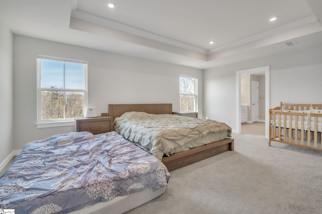 bedroom with carpet floors, a tray ceiling, recessed lighting, and visible vents