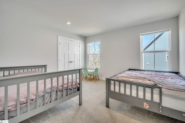carpeted bedroom featuring recessed lighting and baseboards