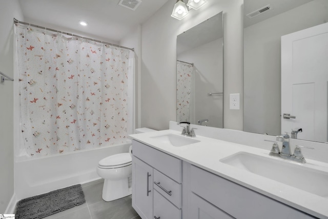 bathroom with toilet, visible vents, a sink, and tile patterned flooring