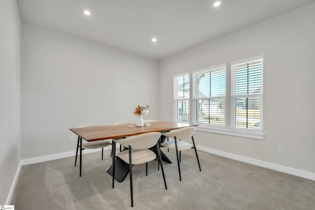 dining area with recessed lighting, baseboards, and light carpet