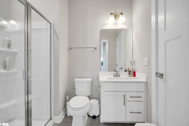 bathroom featuring vanity, toilet, and a stall shower