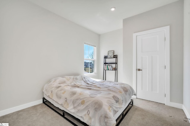 bedroom with carpet flooring and baseboards