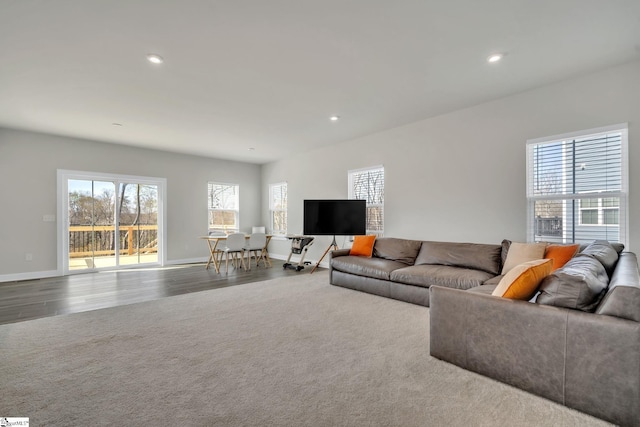 living room featuring recessed lighting, baseboards, and wood finished floors