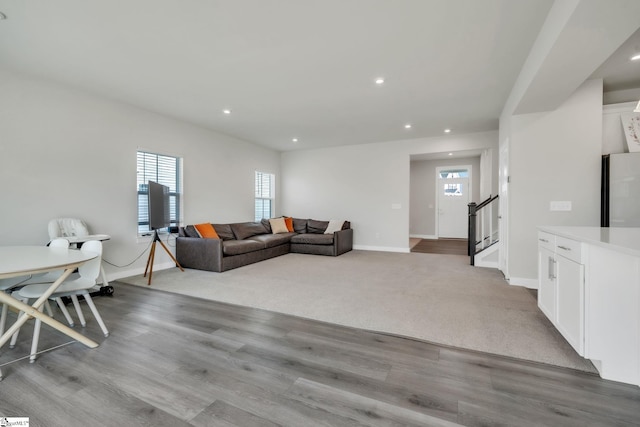living area featuring stairway, baseboards, recessed lighting, and wood finished floors