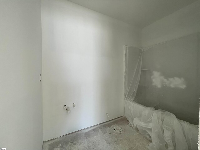 empty room with concrete flooring