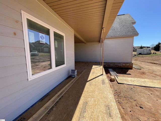 view of side of property with a shingled roof
