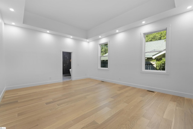 spare room featuring baseboards, recessed lighting, and light wood finished floors