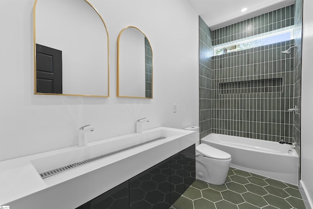 bathroom with toilet, tile patterned flooring, vanity, and washtub / shower combination