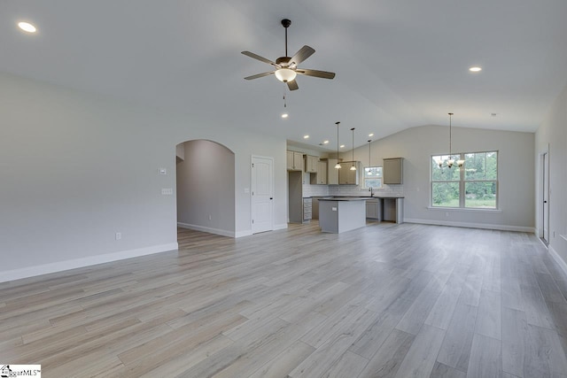 114 Walters Way, Pickens, SC 29671 - unfurnished living room featuring lofted ceiling, ceiling fan, arched walkways, baseboards, and a chandelier