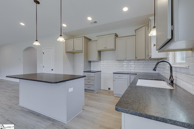114 Walters Way, Pickens, SC 29671 - kitchen featuring a sink, dark countertops, arched walkways, a center island, and recessed lighting