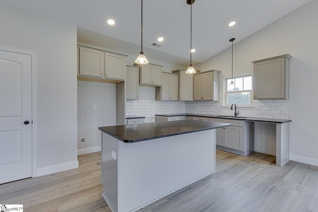 114 Walters Way, Pickens, SC 29671 - kitchen featuring a sink, decorative backsplash, light wood finished floors, dark countertops, and baseboards