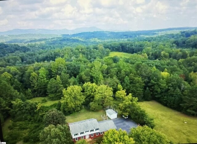 2506 E Tyger Bridge Rd, Greer, SC 29651 - aerial view of property and surrounding area featuring a heavily wooded area and a mountainous background