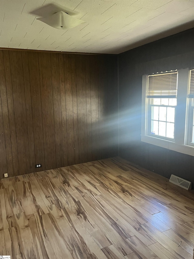 1273 Powerhouse Rd, Ware Shoals, SC 29692 - spare room featuring visible vents, wooden walls, and wood finished floors