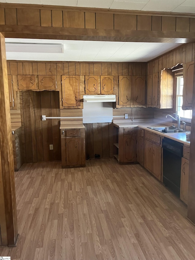 1273 Powerhouse Rd, Ware Shoals, SC 29692 - kitchen with light countertops, black dishwasher, under cabinet range hood, a sink, and light wood-type flooring