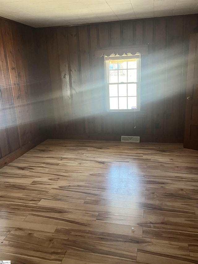 1273 Powerhouse Rd, Ware Shoals, SC 29692 - empty room with visible vents, wood finished floors, and wood walls
