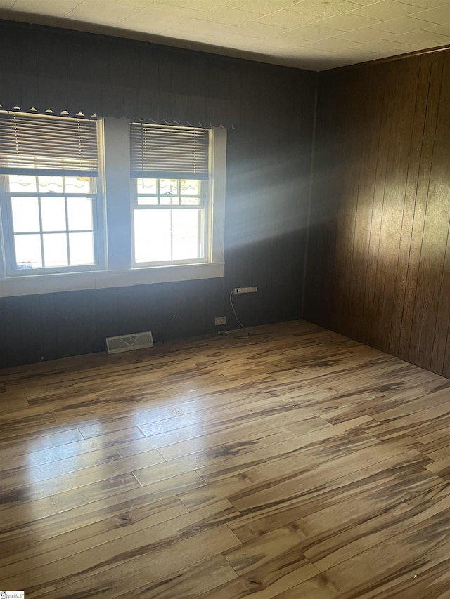 1273 Powerhouse Rd, Ware Shoals, SC 29692 - unfurnished room featuring wood walls, visible vents, and wood finished floors