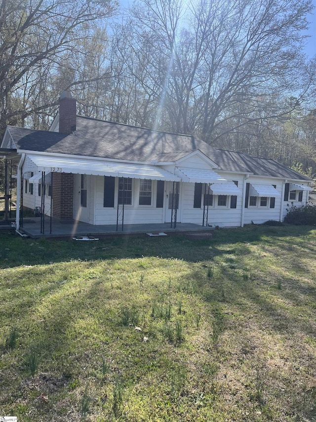 1273 Powerhouse Rd, Ware Shoals, SC 29692 - ranch-style home with a chimney, a front yard, and a patio area