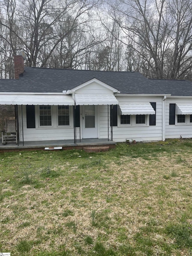 1273 Powerhouse Rd, Ware Shoals, SC 29692 - ranch-style house featuring a front lawn, a chimney, a shingled roof, and covered porch