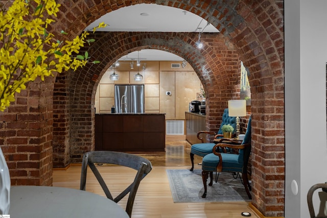 400 E Washington St Unit 28, Greenville, SC 29601 - interior space with visible vents, wood finished floors, arched walkways, and brick wall