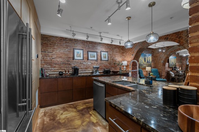 400 E Washington St Unit 28, Greenville, SC 29601 - kitchen with a sink, high end fridge, stainless steel dishwasher, brick wall, and arched walkways