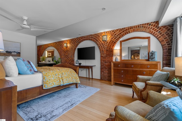 400 E Washington St Unit 28, Greenville, SC 29601 - bedroom featuring wood finished floors, ceiling fan, and brick wall