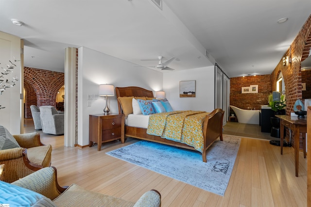 400 E Washington St Unit 28, Greenville, SC 29601 - bedroom featuring light wood finished floors, ceiling fan, and brick wall