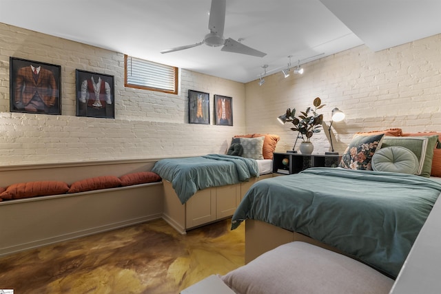 400 E Washington St Unit 28, Greenville, SC 29601 - bedroom with brick wall, ceiling fan, rail lighting, and concrete flooring