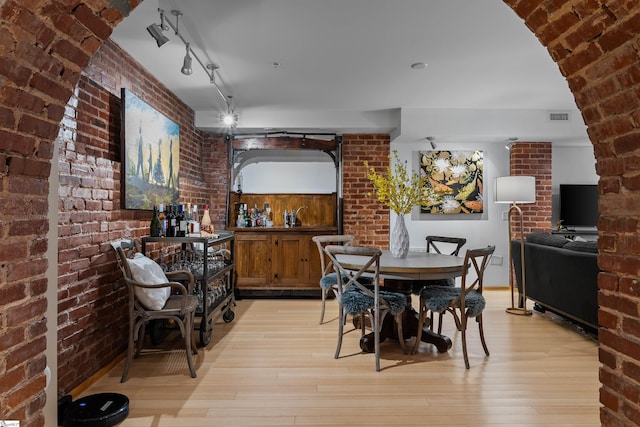400 E Washington St Unit 28, Greenville, SC 29601 - unfurnished dining area featuring light wood-style floors, brick wall, and visible vents