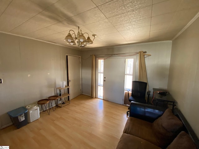 living room featuring a notable chandelier, wood finished floors, and crown molding