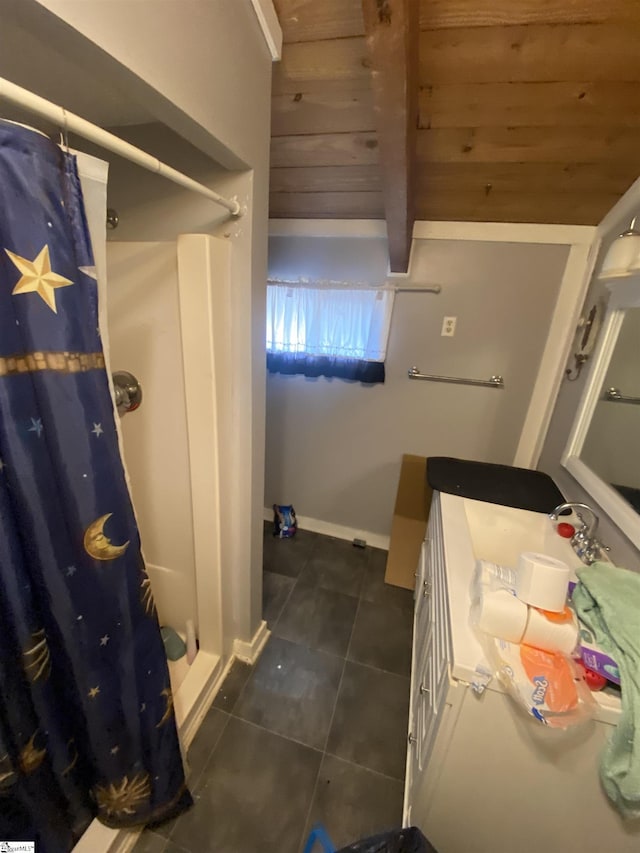 bathroom with tile patterned flooring, vanity, baseboards, and a shower with shower curtain