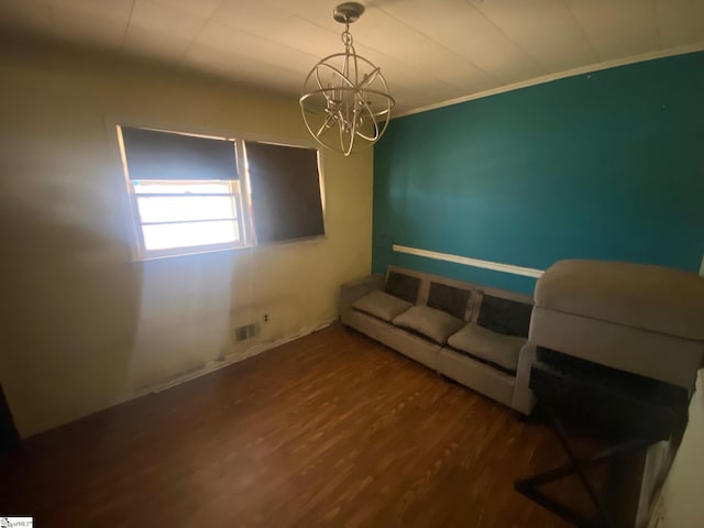 interior space featuring crown molding, visible vents, wood finished floors, and a notable chandelier