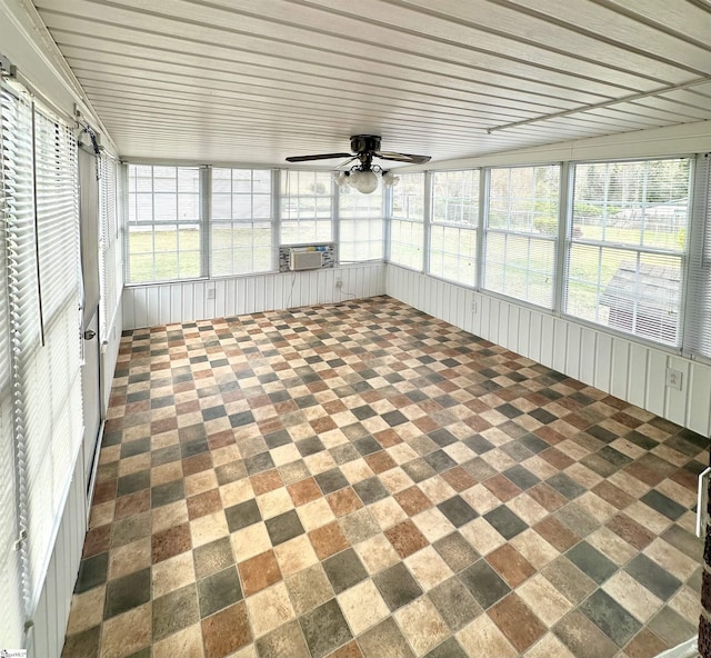 unfurnished sunroom with cooling unit and ceiling fan